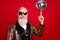 Photo of senior man happy positive smile spin disco ball finger concert showman isolated over red color background