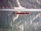 Photo of a serene boat floating on a picturesque lake with a majestic mountain backdrop