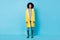 Photo of serious adorable charming dark skin lady wear yellow overcoat isolated blue color background