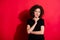 Photo of serious adorable curly woman wear casual black outfit finger chin looking empty space isolated red color