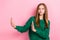 Photo of serious confident girl dressed knitted pullover showing arms stop empty space  pink color background