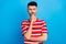 Photo of serious minded young man hold hand chin doubt question isolated on blue color background