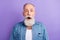 Photo of serious shocked age gentleman wear jeans shirt open mouth big eyes isolated violet color background