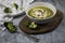 Photo of served brocoli creamy soup with cream and bread croutons on rustic table with spoon and fresh brocoli - photo with