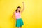 Photo of shiny charming young woman pigtails wear tank top dancing smiling isolated yellow color background