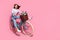 Photo of shiny funky young lady dressed white jumper riding fast bicycle empty space isolated pink color background