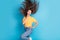 Photo of shiny impressed girl dressed yellow t-shirt finger chin wind blowing hair flying looking empty space isolated