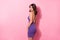 Photo of shiny pretty young lady wear purple glamour outfit standing showing sexy back isolated pink color background