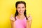Photo of shiny pretty young woman pigtails wear tank top showing give money sign isolated yellow color background