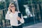 Photo of shiny smiling young lady dressed white formal shirt looking side arm glasses holding clipboard outside