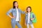 Photo of shiny sweet siblings dressed denim shirts walking school smiling isolated yellow color background