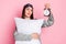 Photo of shiny unhappy young lady sleepwear holding pillow looking retro timer isolated pastel pink color background