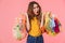 Photo of shocked angry woman holding bags with plastic waste