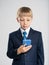 Photo of a shocked businessman  boy with smartphone.  Portrait of a excited  kid in a blue business suit holding a cell phone.