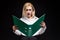 Photo of shocked businesswoman wearing eyeglasses holding paper folder in the office isolated over black background