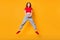 Photo of shocked jumping lady open mouth wear red crop top jeans shoes isolated yellow color background