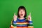 Photo of shocked young amazed woman look point fingers up empty space isolated on green color background