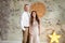 Photo shoot in the studio of a young married couple. A guy with a girl in festive clothes are celebrating Christmas. New Year`s