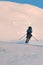 photo shot of jumping male skier against backdrop of snowy mountain slope