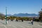 The photo showcases a beautiful viewpoint inside Queen Elizabeth Park in Vancouver, with majestic mountains serving as the