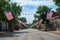 This photo showcases a street adorned with American flags and bunting, creating a patriotic atmosphere, An idyllic midwestern town