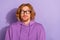 Photo of shy wavy orange hairdo guy look promo wear eyewear violet hoodie isolated on purple color background