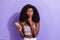 Photo of silent young afro american woman hold finger lips use smartphone isolated on violet color background