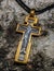 Photo of a silver orthodox cross with gilding on a birch background