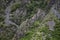 Photo of a small church on the slope of a wooded mountain