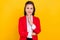 Photo of smart aged brunette lady hand face wear red jacket isolated on yellow color background