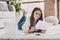 Photo of smart business lady lay carpet netbook hold document read wear glasses white sweater in living room home