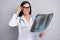 Photo of smart doctor lady examine x-ray wear eyeglasses stethoscope white uniform isolated grey color background