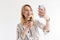 Photo of smiling attractive woman wearing glasses taking selfie photo and holding paper cup