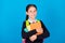 Photo of smiling beautiful intelligent schoolgirl hug books wear backpack isolated on blue color background