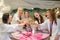 Photo of smiling females drinking champagne at a bachelorette party in spa salon
