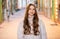 photo of smiling teen curly girl outside. teen curly girl on brick background. teen curly girl