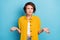 Photo of speechless confused puzzled lady shrug shoulders wear yellow shirt isolated blue color background