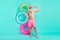 Photo of sportive bodybuilder man hold inflatable circle show biceps wear sunglass shorts isolated teal color background