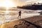 Photo of a sportsmen running on the beach during sunset. Outdoor workout