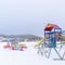 Photo Square Colorful playground that contrasts against the snow covered winter landscape