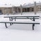 Photo Square frame Cold winter day at a park with picnic tables and benches covered with snow