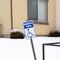 Photo Square frame Handicapped Parking sign and wheelchair ramp at a snowy parking lot in winter