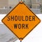 Photo Square frame Shoulder Work sign on the snowy sidewalk of road under construction in winter