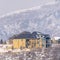 Photo Square Hilly residential terrain with charming homes and snowy natural beauty