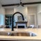 Photo Square Kitchen island with double basin undermount sink black faucet and fruit basket
