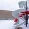 Photo Square Snow blanketing a park with benches and slides on a cold winter landscape