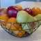 Photo Square Wire geometric basket with fresh fruits against kitchen island faucet and sink