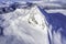 Photo of standalone big mountain in Scandinavia, cold sunny day, blue sky, closer aerial photo of wild subarctic nature taken from