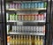 Photo of a store cold fridge door filled with Water Loo, Celsius and Izze Lemonade drinks