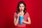 Photo of stunned lady cinema watch movie drink cola soda lemonade ice tea wear striped top isolated red color background